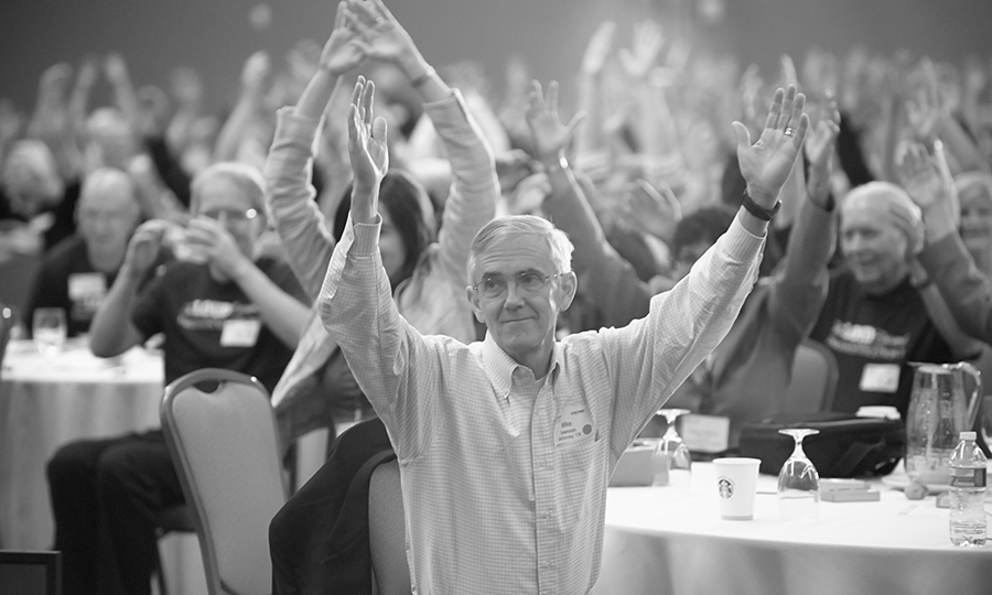 The Victory Summit attendees raise arms together