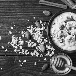 healthy homemade oatmeal porridge with nuts, banana, cinnamon and honey