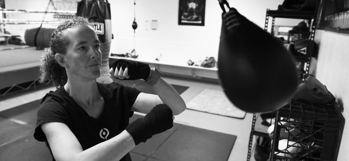 Woman follows her Parkinson's exercise program at boxing gym