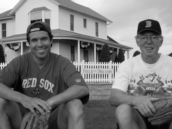 Robert and Dan Cochrane smile together wearing Red Sox jerseys