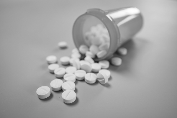 bottle of pills spilled across counter for Ritalin and Parkinson's