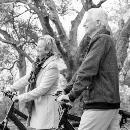Parkinson's couple exercise in the park with bikes