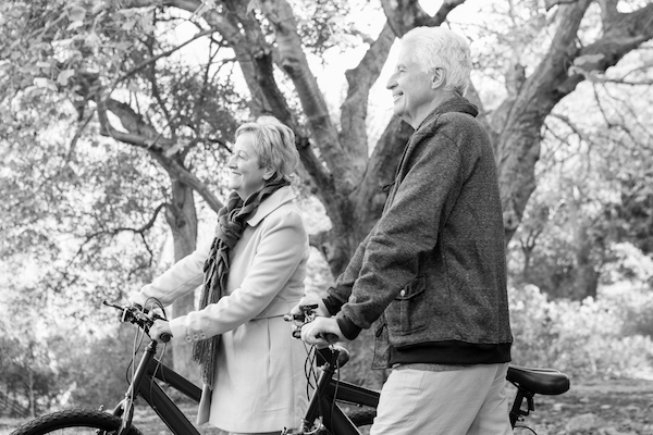 Parkinson's couple exercise in the park with bikes