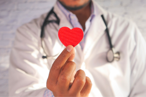 Doctor holding heart sticker