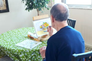 Person painting at table