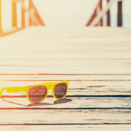 yellow sunglasses on boardwalk