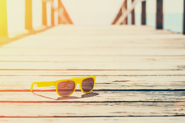 yellow sunglasses on boardwalk