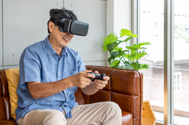 Senior man playing virtual reality game