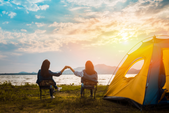 two women camping on lake