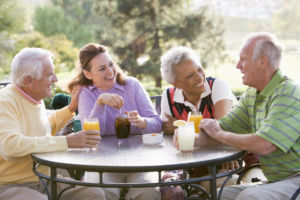 Four adults at outdoor table