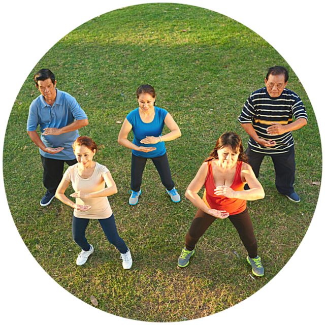 Group of five adults practicing tai chi in park