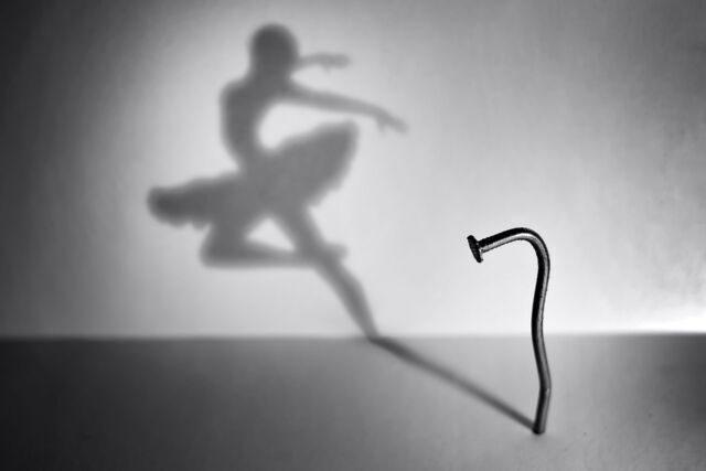 Concept: silhouette of a ballerina designed on a wall from an old nail
