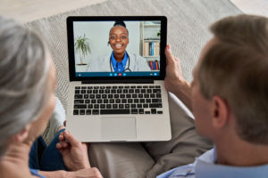 video calling virtual doctor using laptop at home