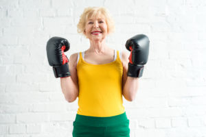 woman in boxing gloves smiling at camera