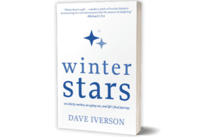 The cover uses shades of blue on a white background. At the top, there is a quote from Michael J. Fox. It says, "Winter Stars is a gift- a modern classic of frontier literature documenting the uncertain journey into the country of caregiving." His name is listed below that. Underneath are three four-pointed stars, the largest being dark blue, then classic blue, and then light blue. The title "Winter Stars" is in all lowercase font. Underneath, in italics, it says "an elderly mother, an aging son, and life's final journey". Finally, it says "DAVE IVERSON" across the bottom.