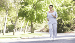Smiling woman jogs in park