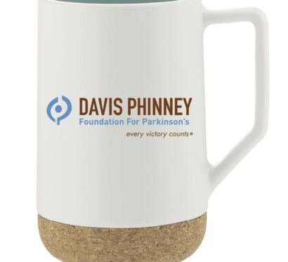 A white mug with a cork bottom that says "Davis Phinney; Foundation For Parkinson's: every victory counts®" in brown, blue, and brown. The logo for the Foundation is to the left of the text and is blue.