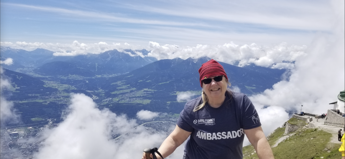 moments of victory carol clupny. Carol is atop a mountain in her Davis Phinney Foundation Ambassador shirt.