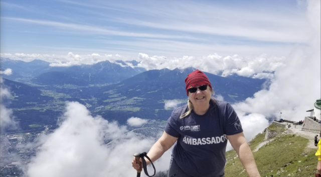 moments of victory carol clupny. Carol is atop a mountain in her Davis Phinney Foundation Ambassador shirt.