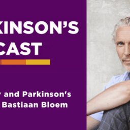 The parkinson's podcast logo on a purple background with the words "mortality and Parkinson's with Dr. Baastian Bloem. On the right side of the image is a picture of Dr. Bloem in front of a white pillar with white hair, a white bear, and a light blue shirt. His arm is resting on his knee. He is wearing black pants and his knee is bent. He is white.